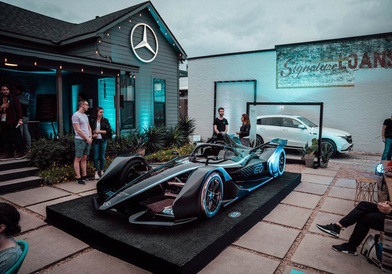 Mercedes Benz EQ race car displayed at LACE event during SXSW 2019 with people and branded building in background