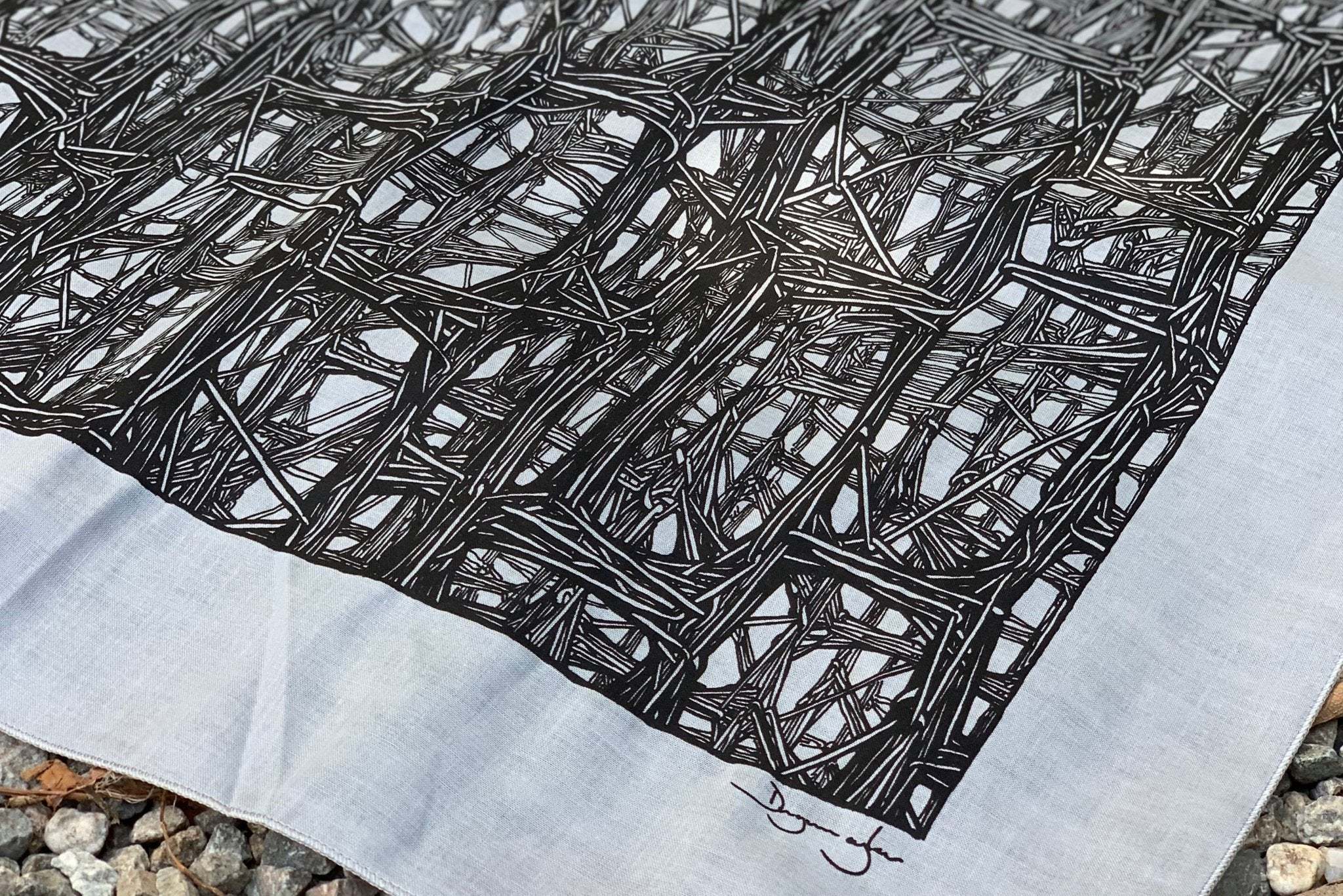 Close-up of Lineworks Bandana featuring intricate black linework design on white cotton fabric