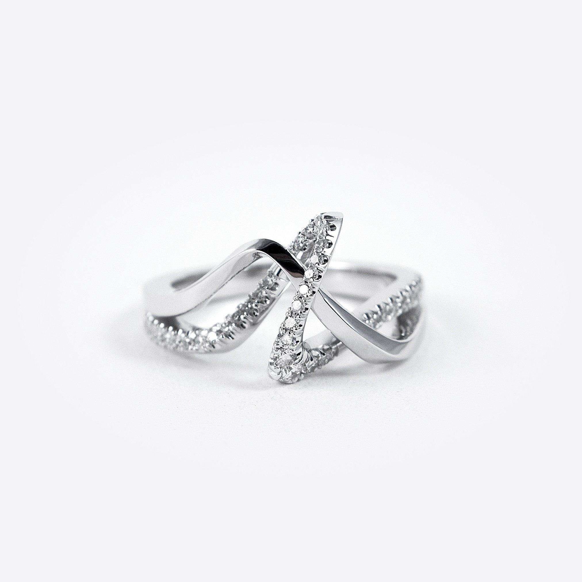 Amare Diamond Ring featuring a unique loose knot design with intertwined diamond-pave and polished metal lines
