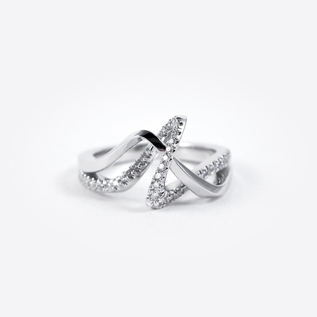 Silver engagement ring sample with crisscross design and embedded stones