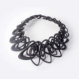 Black 3D printed Catena Necklace with interlocking elliptical petals made from flexible TPU polymer
