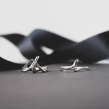 Amare Sera Ring set of two sterling silver rings with knot design on gray surface