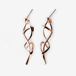 Rose gold Nova earrings with elegant undulating knot design and high-precision edges.