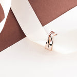 Amor Amos Light Set rose gold stackable twisting rings on white ribbon