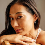 woman wearing delicate silver Calyx Mini Hoop earrings with petal layers