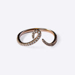 Close-up of Hydra Diamond Ring in 14K gold with curved band adorned with small round brilliant diamonds on white background