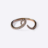 Close-up of Hydra Diamond Ring in 14K gold with curved band adorned with small round brilliant diamonds on white background