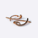 Hydra diamond earrings in 14K rose gold with 0.11 carats round-brilliant diamonds and a modern looped huggie design