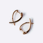 Hydra diamond earrings in 14K rose gold with 0.11ct sparkling diamonds in a modern looped huggie design