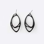Eclipse Carbon Earrings made of 3D printed carbon fiber with two interlocking oval rings and precision edge detailing.