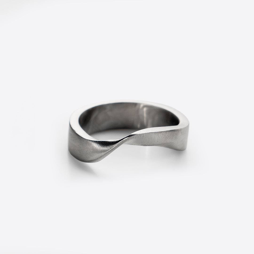 Amos Stainless Steel Ring with minimalist twisting band design on white background