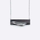 Adagio Stainless Steel Pendant with twisting stacking curves and precision edge detailing on a chain necklace
