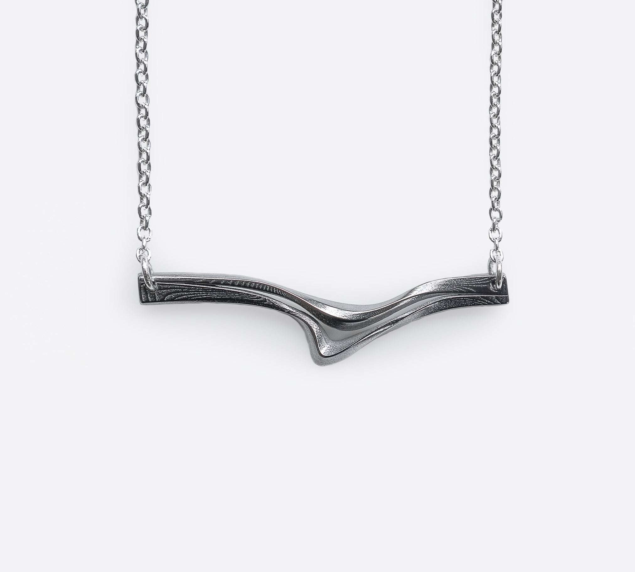 Andante Stainless Steel Pendant with twisting curves and precision edge detailing on a chain necklace