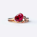 Calyx Sample Engagement Ring with red oval gemstone and gold intertwined band