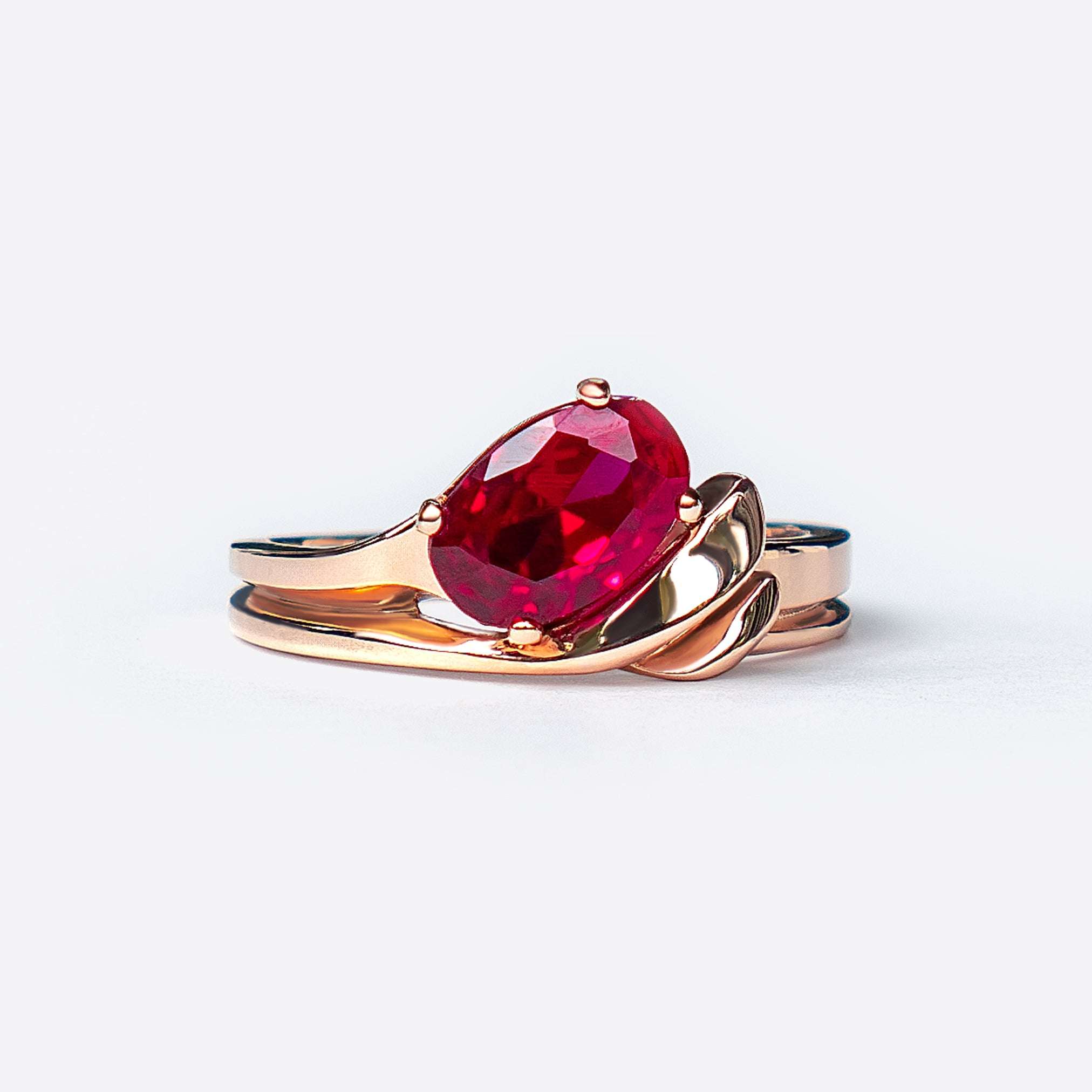 Calyx Sample Engagement Ring with red oval gemstone and gold intertwined band