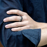 Amor Stainless Steel Ring bold twisted band on finger with dark shirt background