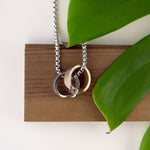 Machina Gift Set stainless steel and bronze men's rings with chain necklace on wooden display with green leaves