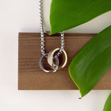 Machina Gift Set stainless steel and bronze men's rings with chain necklace on wooden display with green leaves