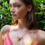 Woman wearing Leda gemstone necklace in 18K rose gold vermeil with amethyst and pink tourmaline accents outdoors