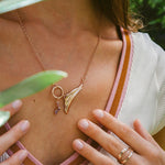 Close-up of Leda gemstone necklace in 18K rose gold vermeil with amethyst and pink stones worn on model's neck