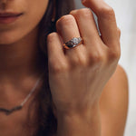 Close-up of hand wearing Iris Diamond Ring with 0.5 carat round lab-grown diamond and intricate drapery design