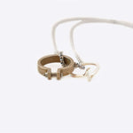 Machina L necklace stainless steel 24-inch Rolo chain with two rings on white background