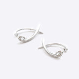 Hydra diamond earrings in 14K white gold with 0.11 carats round brilliant diamonds and modern looped huggie design