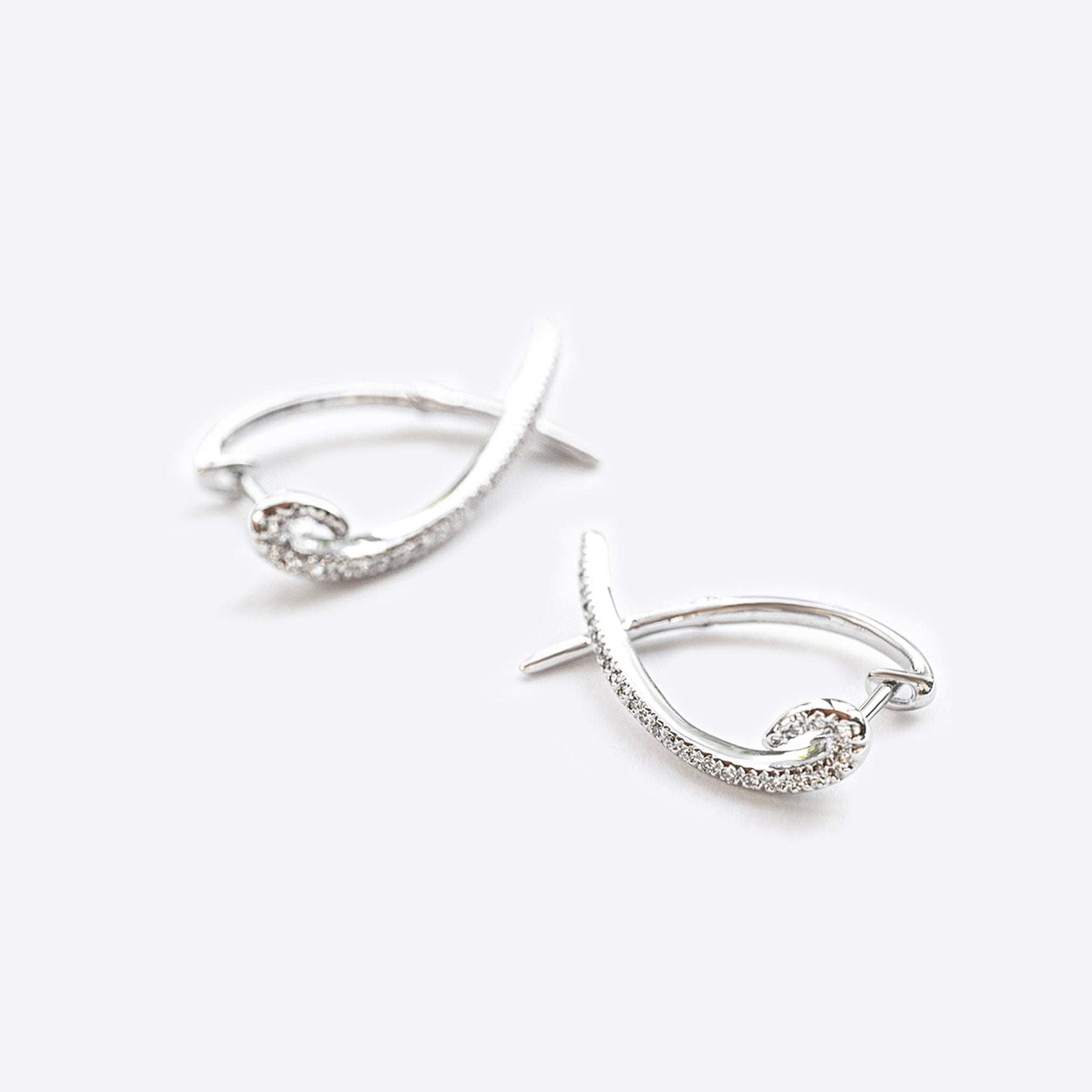 Hydra diamond earrings in 14K white gold with 0.11 carats round brilliant diamonds and modern looped huggie design