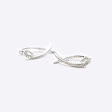 Hydra diamond earrings in 14K white gold with 0.11ct sparkling diamonds in a looped huggie design