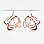 Rose gold Gemino earring with three interlocking elliptical petals design hanging on hooks