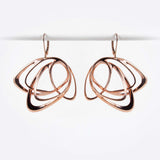 Rose gold Gemino earring with three interlocking elliptical petals design hanging on hooks