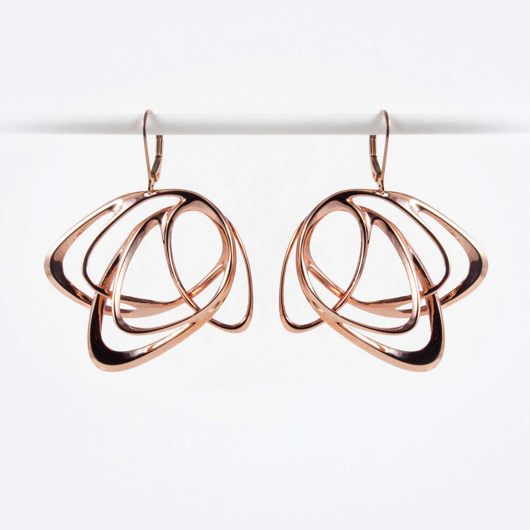 Rose gold Gemino earring with three interlocking elliptical petals design hanging on hooks