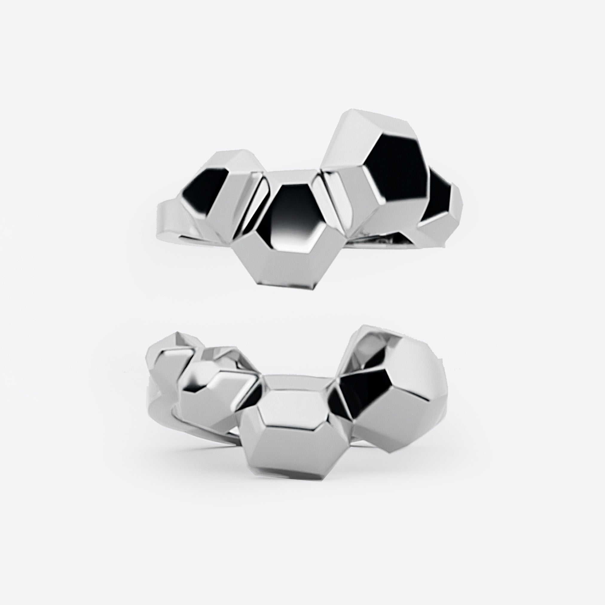 Sterling silver Hexa Rings Set featuring hexagonal geometric design with undulating surfaces, two rings designed to nest together forming a statement ring.