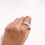 Hand using a white ring sizer measuring finger size with numeric markings