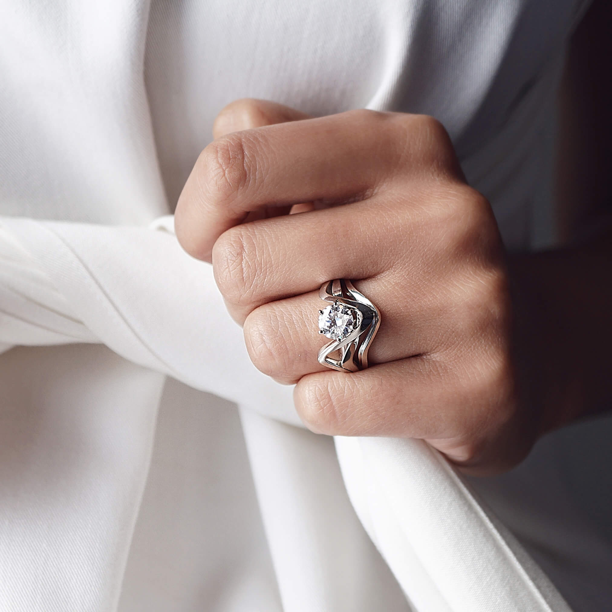 Engagement ring sample worn on hand showcasing design from LACE bridal collection