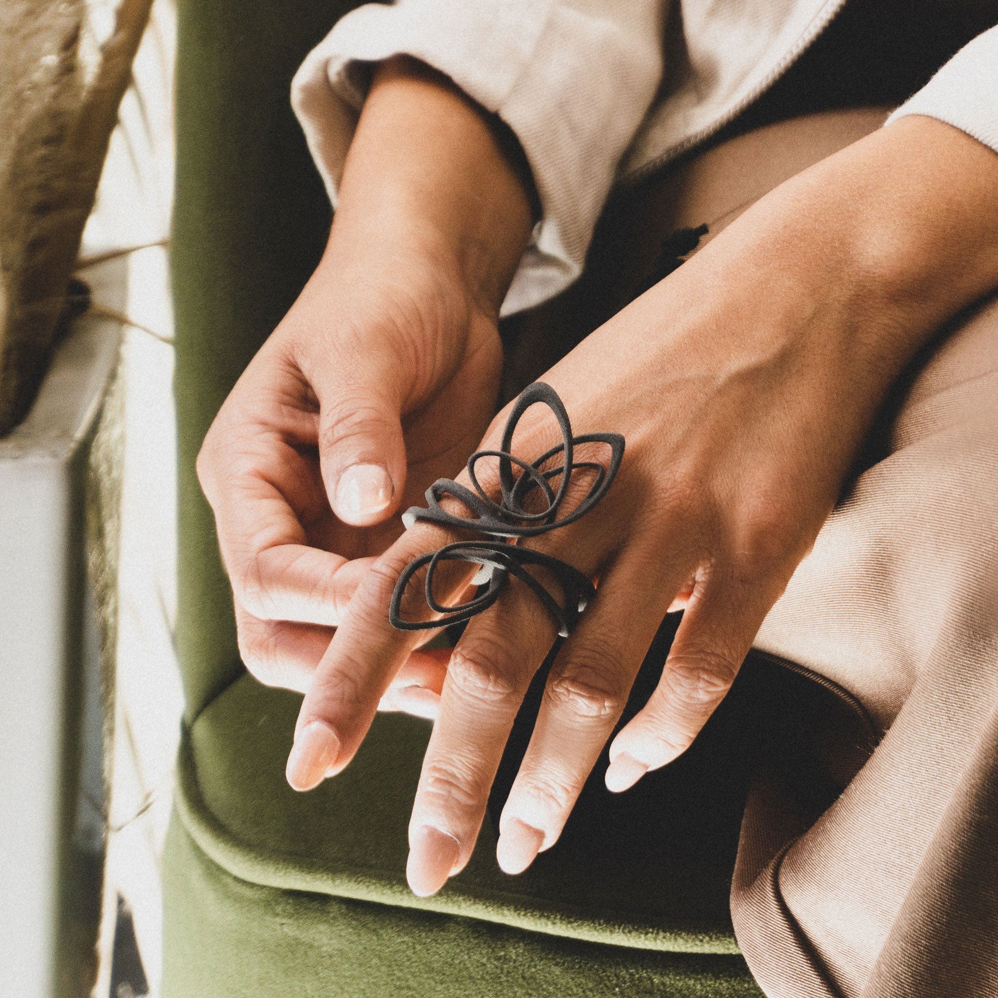 Person wearing multiple black nylon lace ring samples on finger, showcasing Ring Samples Set design options