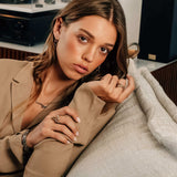 Woman wearing X Steel Ring with crossed tapering lines and precision edge detailing on her finger