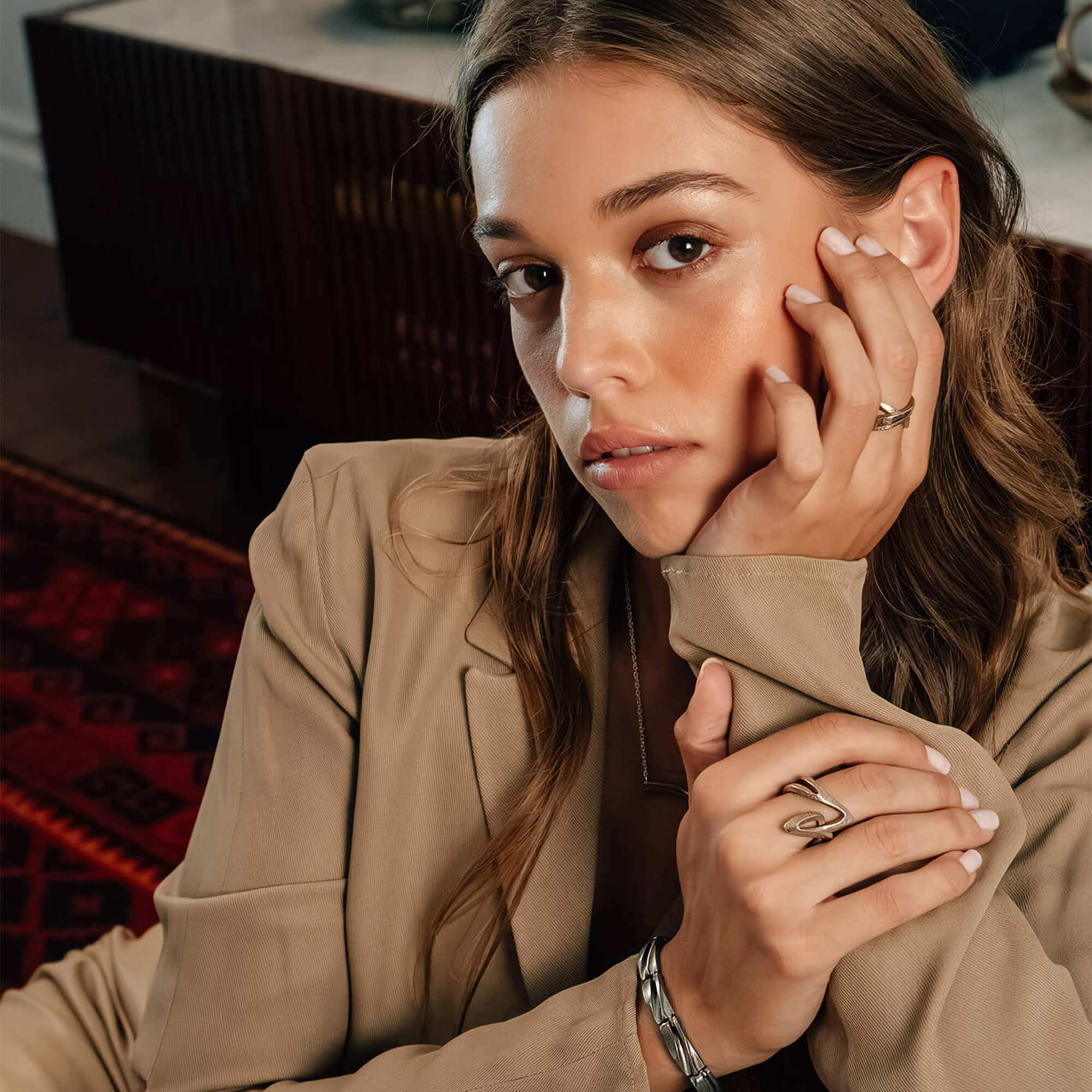 Woman wearing L Steel Ring with twisting lines and precision edge detailing on finger