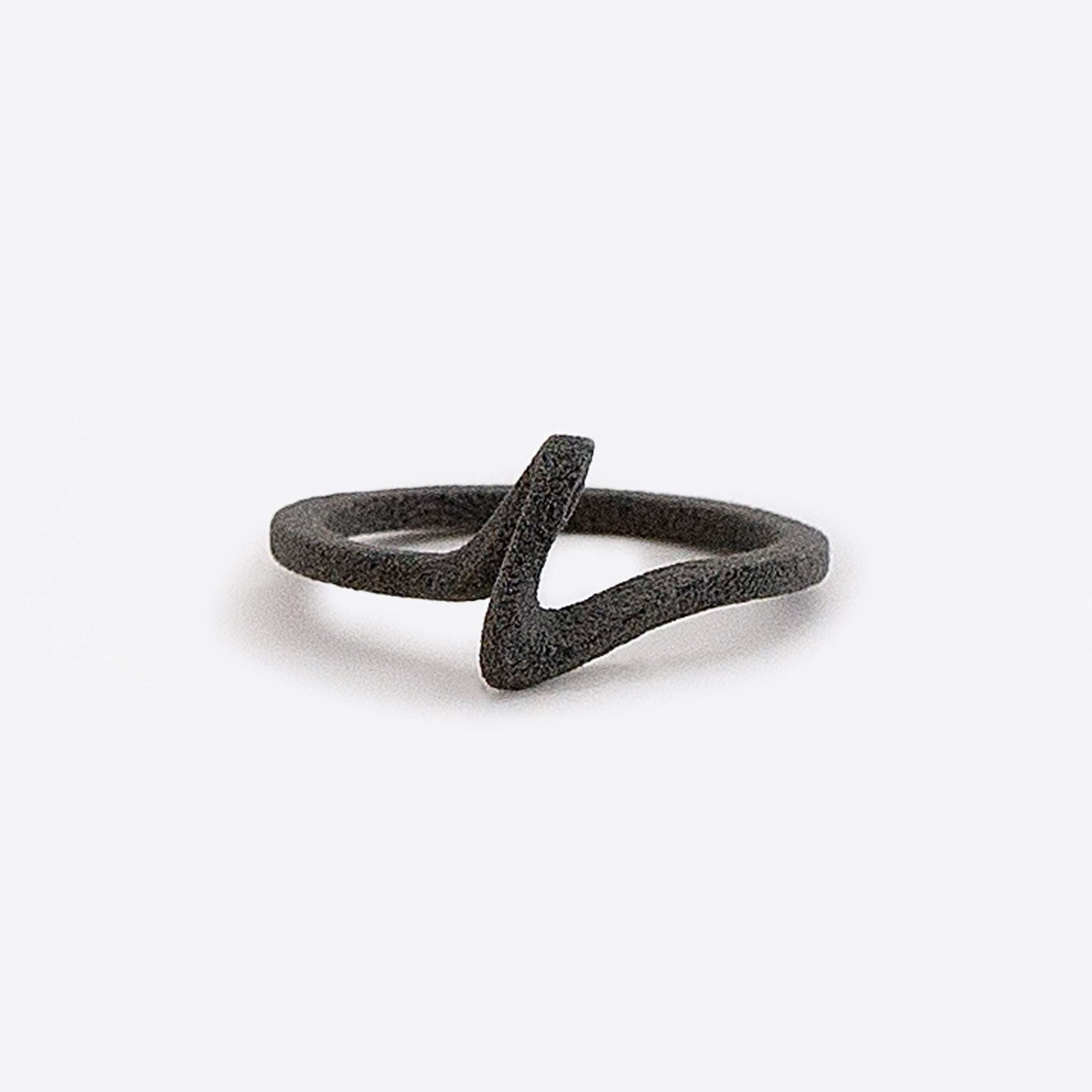 Black nylon engagement ring sample with a delicate curved design on a white background