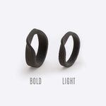 Gray nylon Amor Sample Rings with twisting band design, bold and light styles displayed side by side