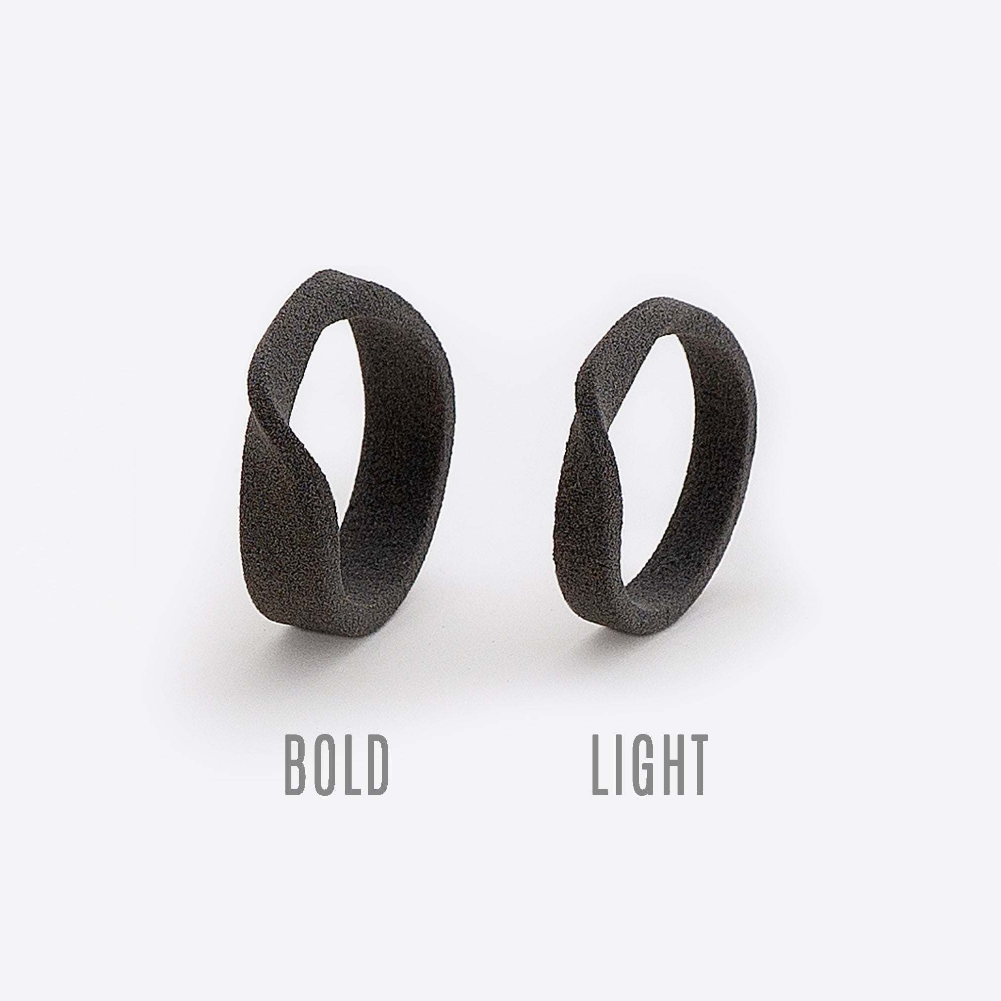 Gray nylon Amor sample rings showing bold and light twisting band designs