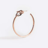 Rose gold vermeil Coda hoop earring with a loose knot detail and precision edges.