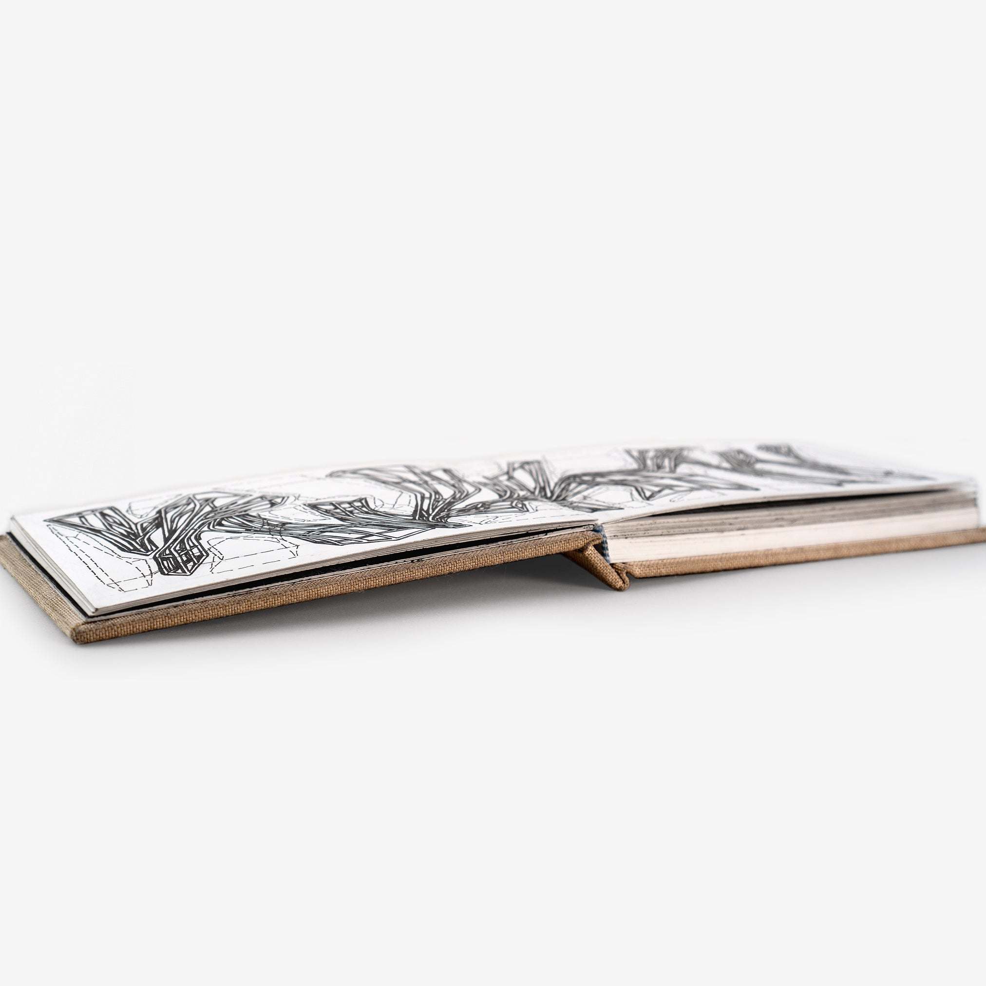 LACE sketchbook with sewn case binding and natural linen cover laying flat with black and white sketches on heavyweight smooth white paper