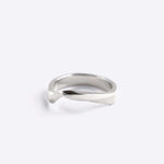 Sterling silver Amos Ring with a minimal twisting band and precision edge detailing on a white background