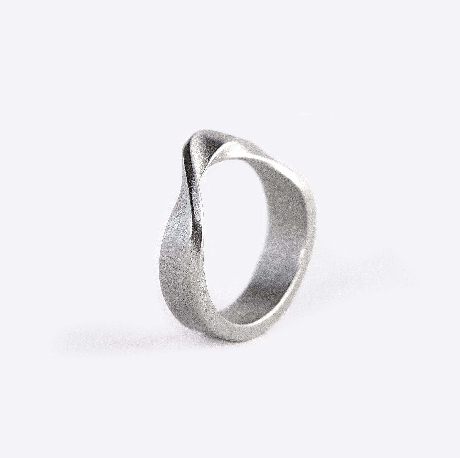 Amos Stainless Steel Ring with twisted band and precision edge detailing on white background