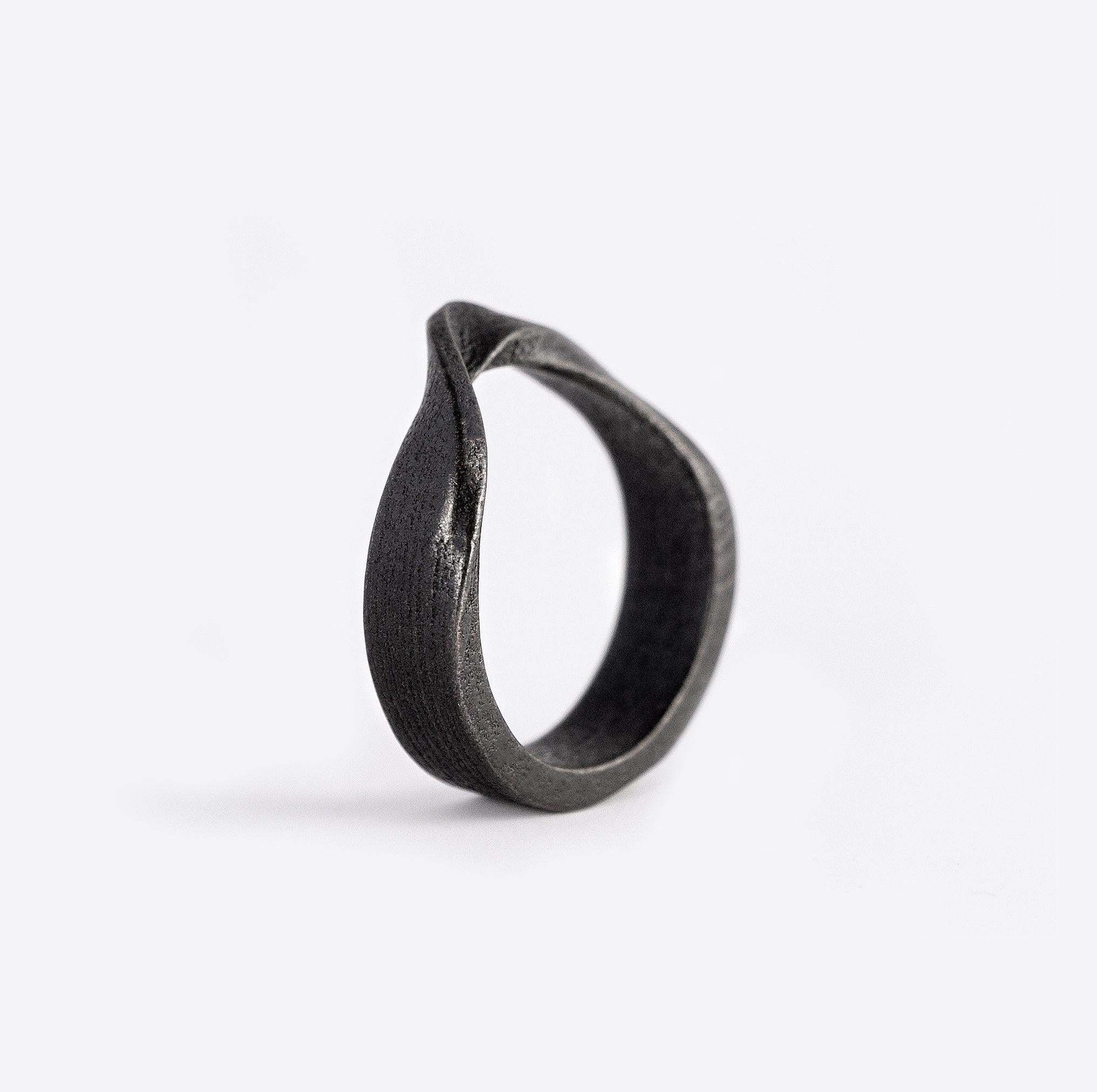 Amos Bold Steel Ring in gray with twisted band and precision edge detailing on white background