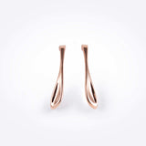 Rose gold Lini earrings with a curved drop shape inspired by a dew drop, available in bold 2-inch length.