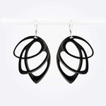 Black polished Orbis Nylon Earrings with three elliptical open loops in descending sizes, hanging on silver hooks