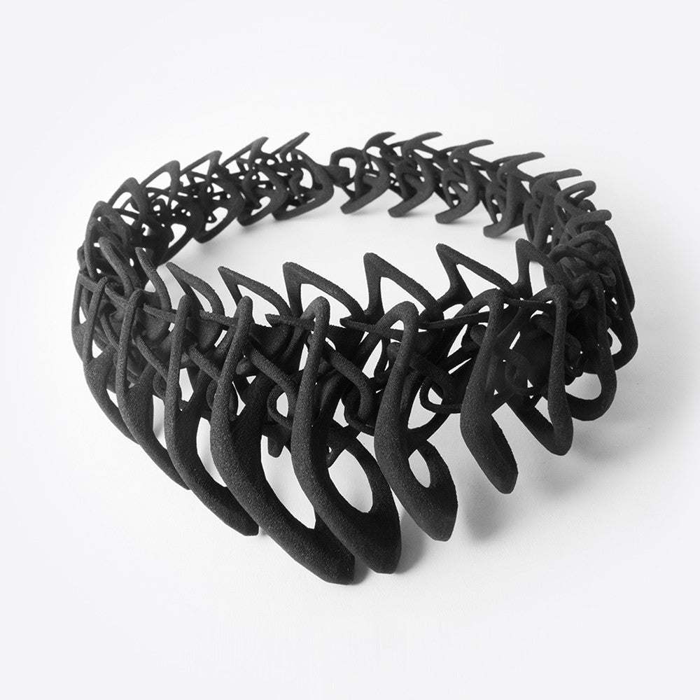 Black 3D printed TPU necklace with interlocking elliptical petals design forming a layered, flexible structure