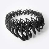 Black 3D printed TPU necklace with interlocking elliptical petals design forming a layered, flexible structure